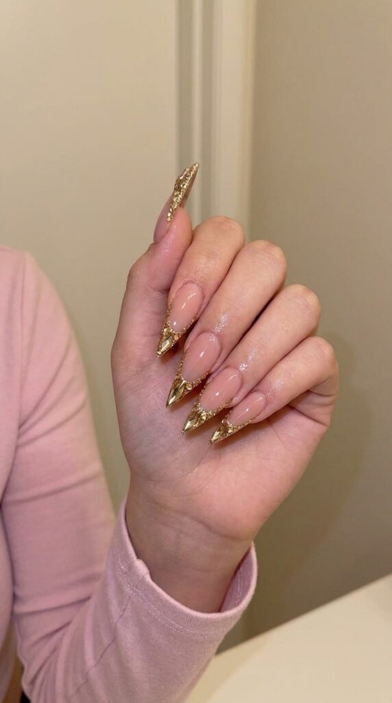 Luxury Nail Design Ideas: Rhinestones, Metallic Tips & Shapes 8 Model painting gold nail tips 202605150254 1