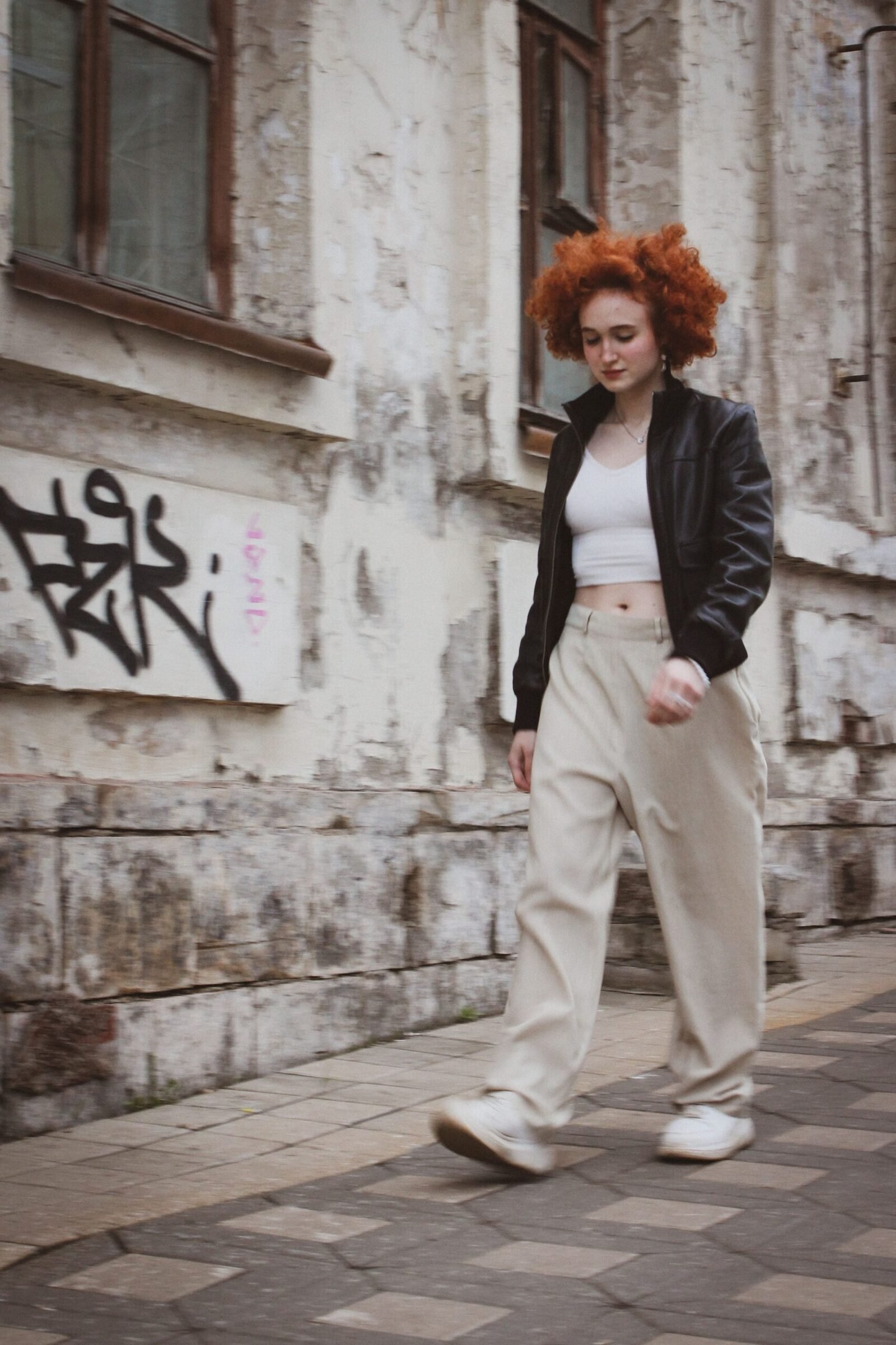 Balloon Pants Outfit Ideas 2026: How to Style the It Trousers 5 Stylish woman in street-style fashion with a leather jacket and relaxed trousers