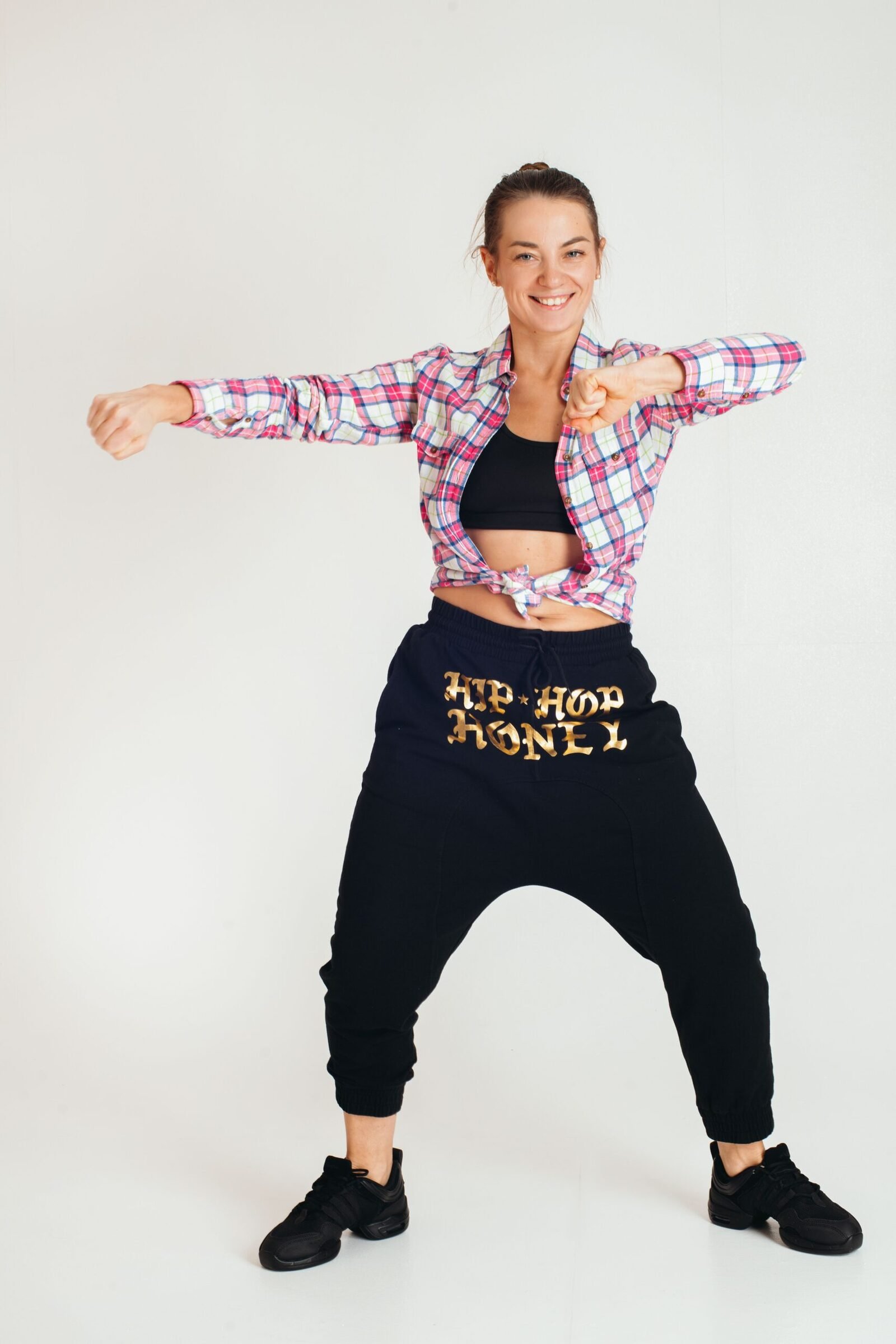 Balloon Pants Outfit Ideas 2026: How to Style the It Trousers 2 Woman posing in baggy balloon-style trousers during a studio fashion shoot