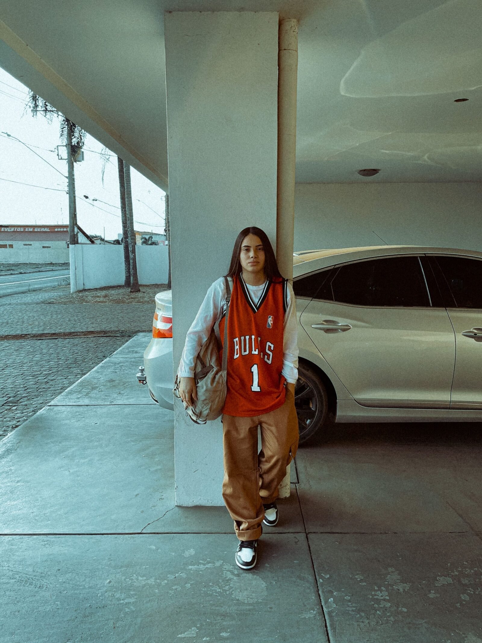 Balloon Pants Outfit Ideas 2026: How to Style the It Trousers 4 Young woman in a relaxed sporty outfit in a car park — athleisure way to wear balloon pants