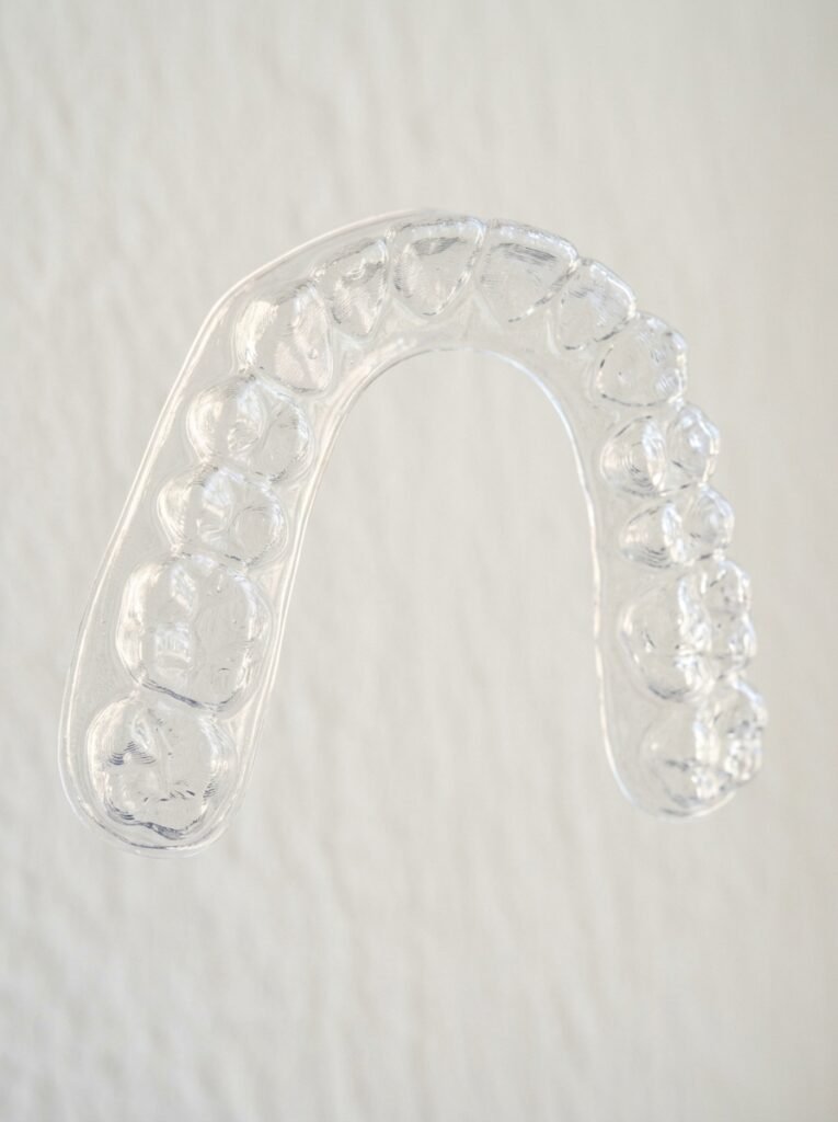 Invisalign Cost and Timeline: Complete Adult Guide 2026 2 Orthodontic aligner tray held 202608302314
