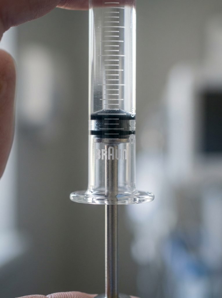 Botox Cost Per Unit: Real Prices Around The World 3 Syringe held upright against bac… 202609010102